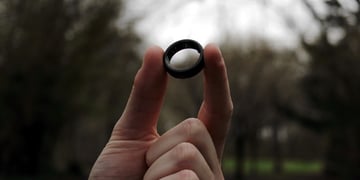 smart ring held up in forest